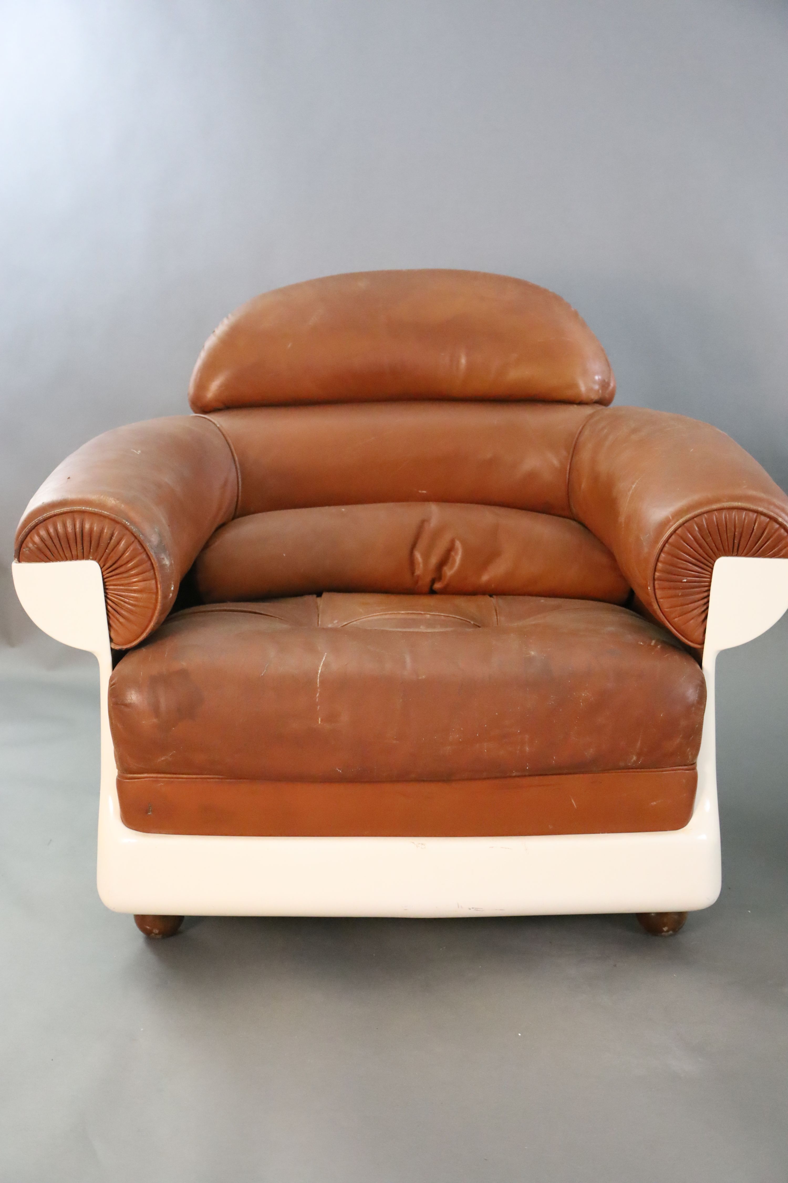 A pair of mid century tan leather and fibreglass tub chairs, possibly French, by Airbourne, W.3ft 1in. D.2ft 7in. H.2ft 8in.